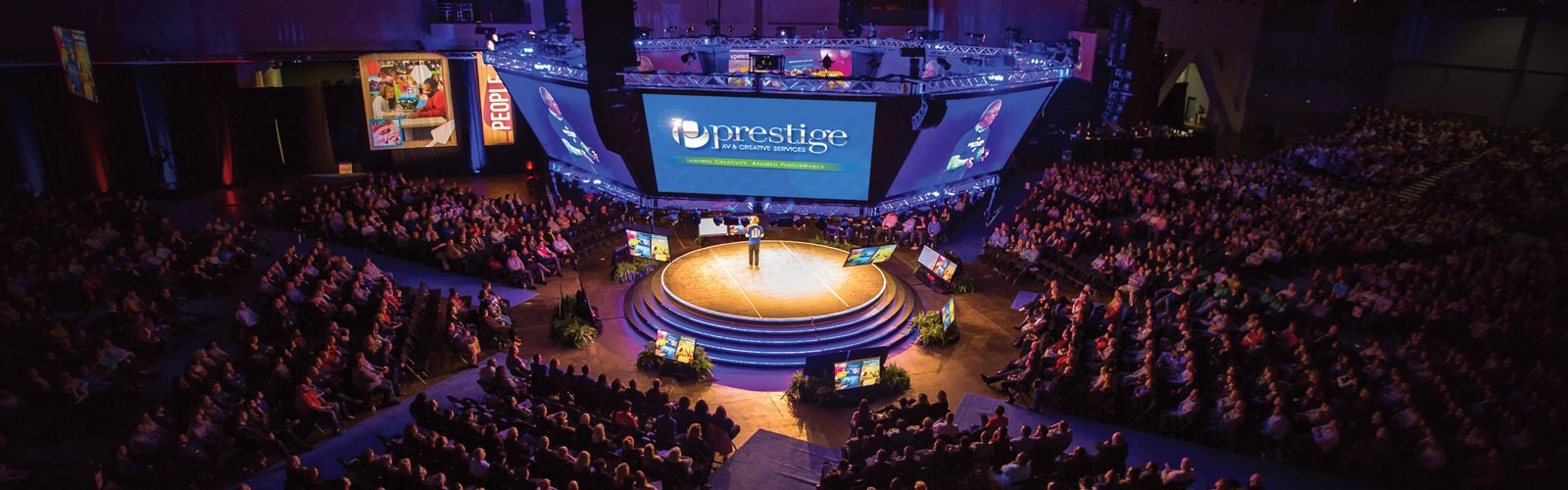 Prestige AV & Creative Services supports corporate meetings of all sizes including this “in the round” multi-screen set for 4,000 attendees.