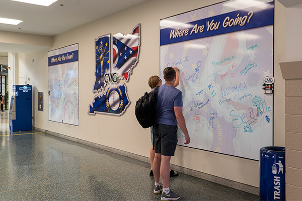 Interactive dry erase boards ask passengers where they're from and where they're going.