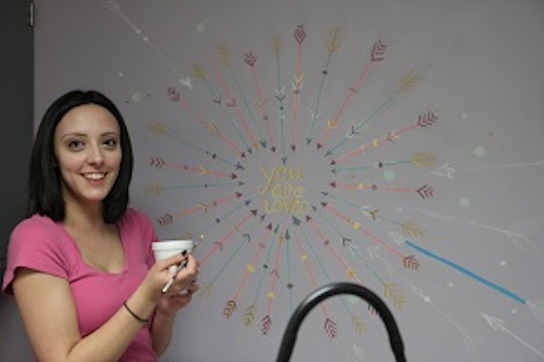 UC fine arts student Jordan Stephens helps spruce up the Price Hill Health Center