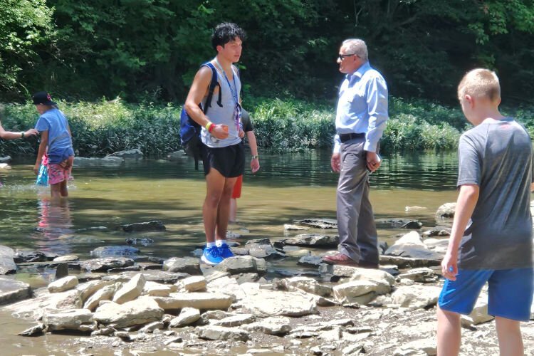 President and CEO of the YMCA of Greater Cincinnati, Jorge Perez, in the field with a team leader.