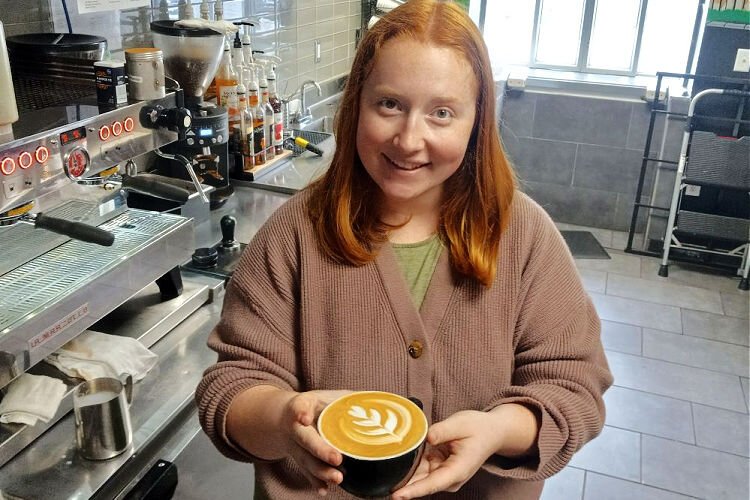 The 2023 Latte Art Throwdown winner, Robbie Blankenship, demonstrates her skill while working at Hyde Perk Coffee. She said, “I've been working to improve my latte art skills since I could pour my first heart.”