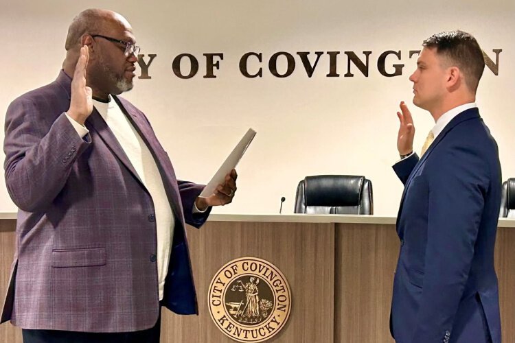 Mayor Washington administering the oath of office to Covington police officer Josh Galvin.