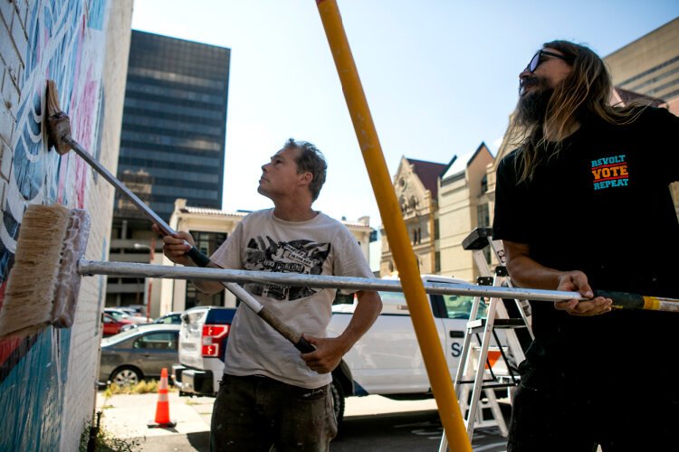 Renowned street artist Shepard Fairey installs his get-out-the-vote artwork.