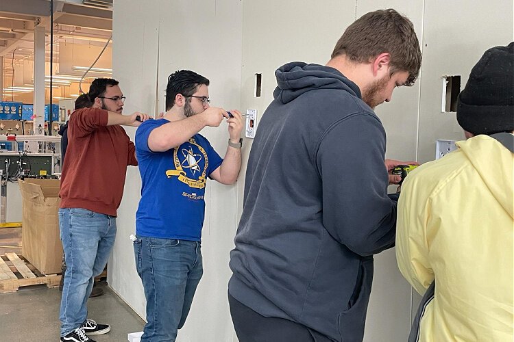 Students in a hardware and software course in the Computer Information Technology Program at Gateway Community and Technical College learn to install Wi-Fi equipment.