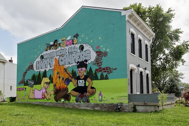 Visitors are greeted with a mural depicting the town's past and present.