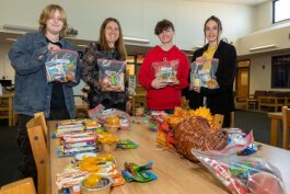 Helping Hands for the Homeless team making survival kits. l to r - Jean Adkins, Jodie Petersime, Declan Sefton, and Mason Heitman.