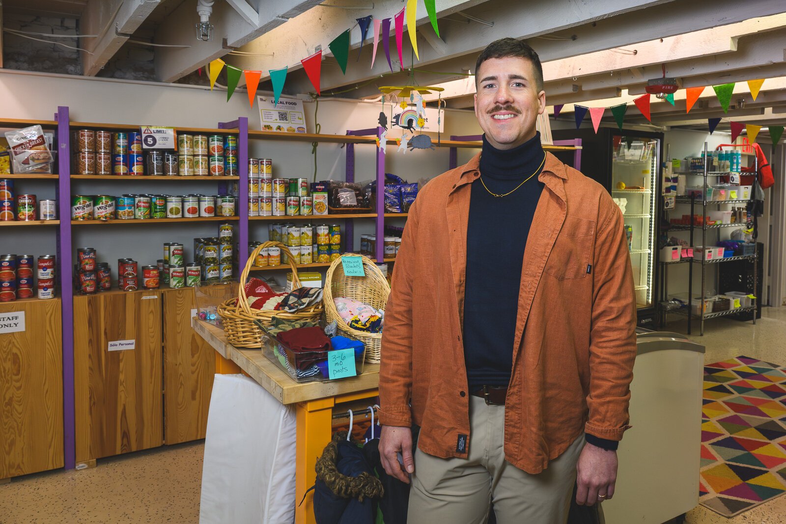 Executive Director Alex Plum at Corner Health Center's clothing closet and food pantry.