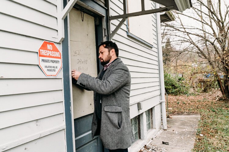 Andrew Fisher of The Port inspects one of the agency-owned houses in East Price Hill. Photo Natalie Grilli. 