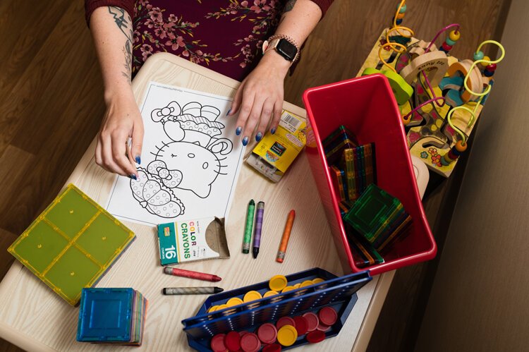 Dr. Gabrielle Paul, a child and adolescent psychiatrist, sometimes colors and plays games with her young patients.